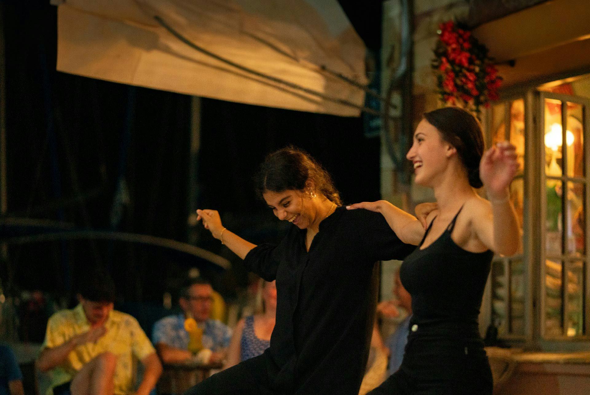 Two women dancing at a bar in Greece